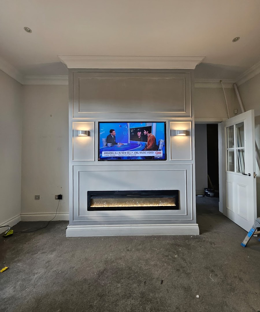 Large panelled media wall unit mid-installation