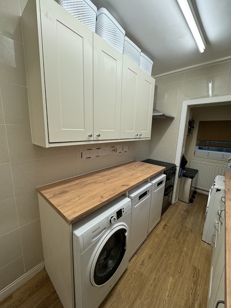 Kitchen units and worktop fitted along a utility run