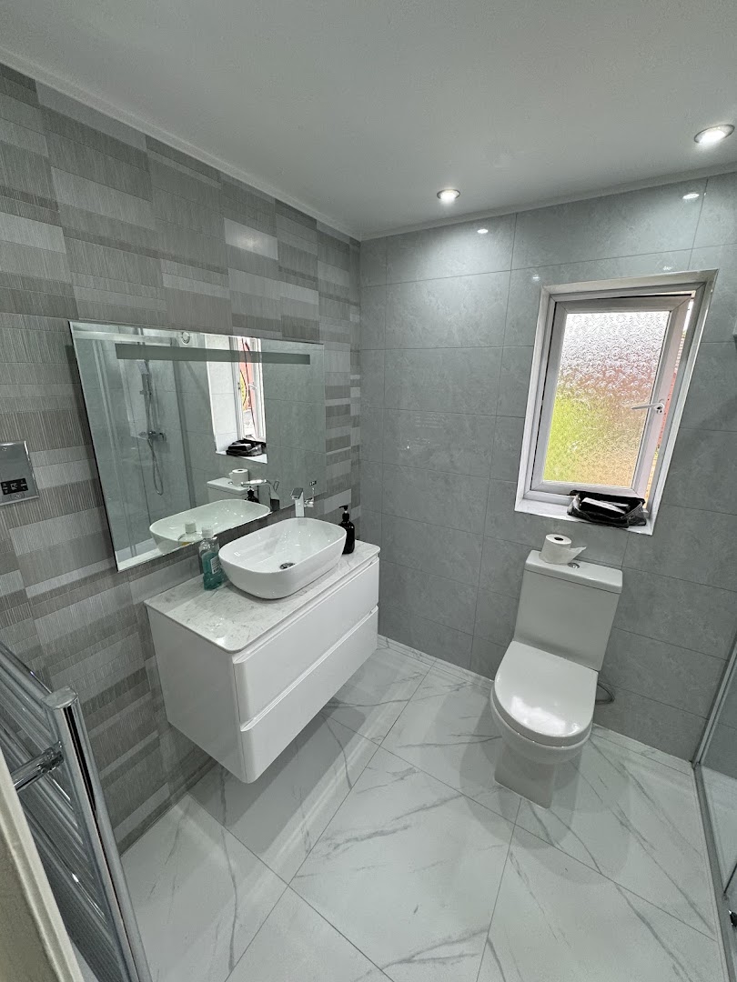 Refitted bathroom with grey tiling and floating vanity