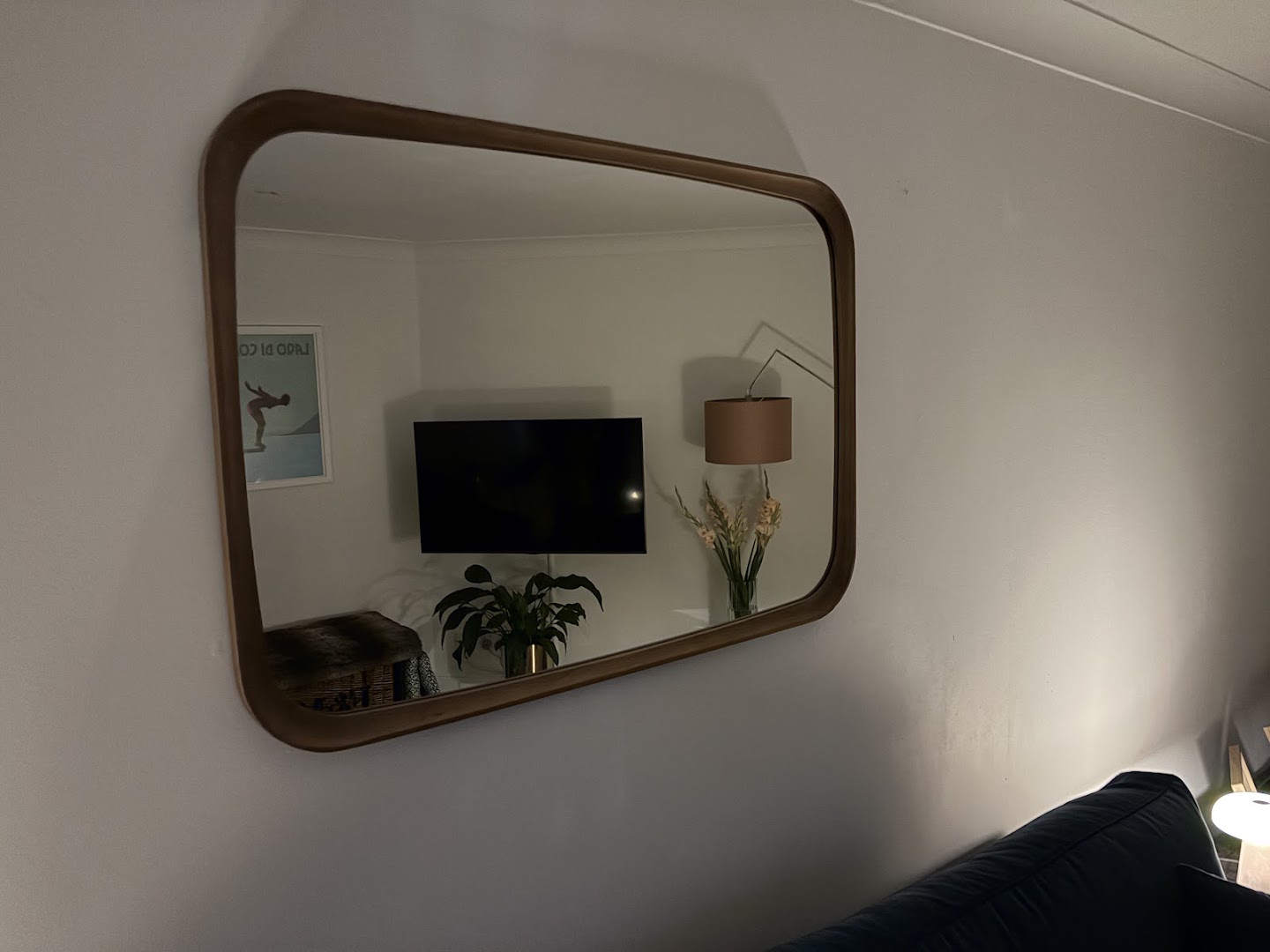 Large framed mirror hung on a living room wall